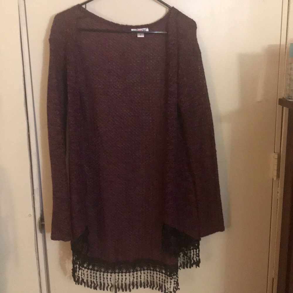 Red cardigan with black fringe at the bottom